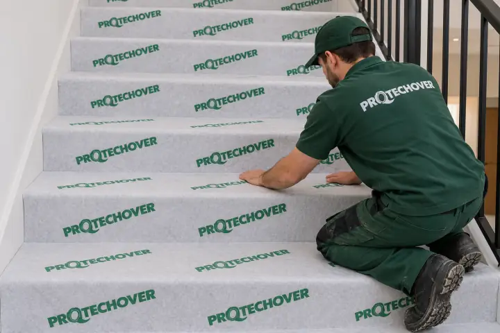 Installer fitting Protechover covering on stair treads